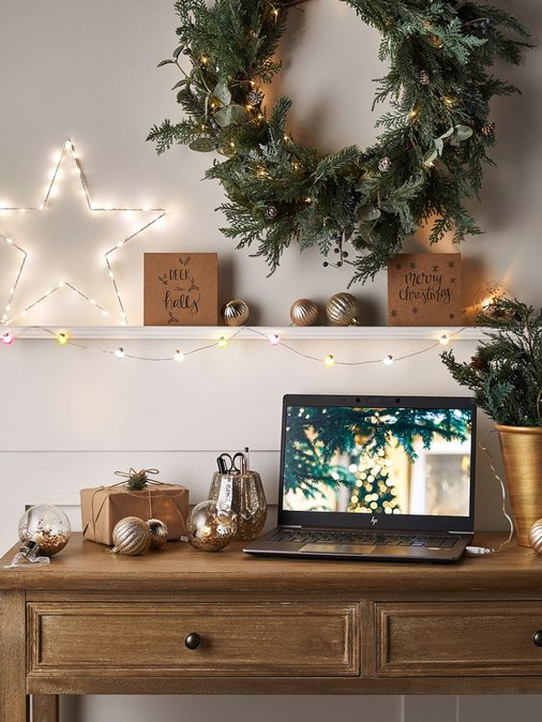 traditional-christmas-home-office-with-wreaths-star-and-string-lights