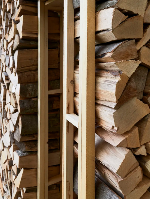 pine-wood-cabin-frame-with-oak-firewood-wall