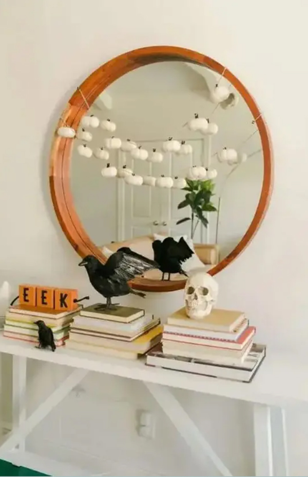 stylish-halloween-bookcase-decor-with-wooden-frame-mirror